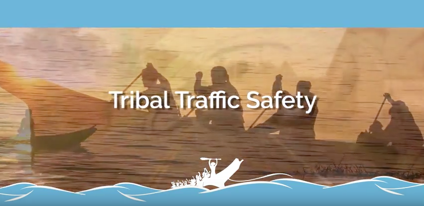 Video image showing native americans paddling a traditional canoe.